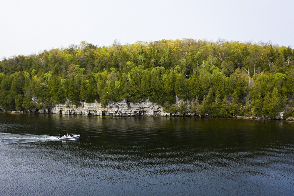 Boat driving in front of escarpment