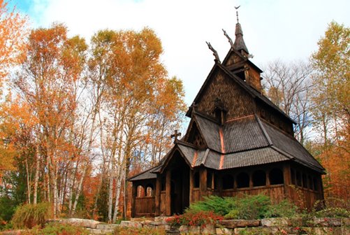 A wooden building in a clearing surrounded by trees