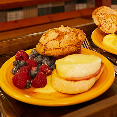 Closeup of a beautiful breakfast spread on a bed.