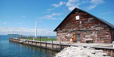 Graffiti cabin building near a pier on the lake