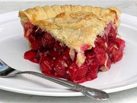 A slice of cherry pie on a plate.