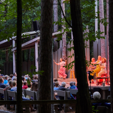 Group performing theater in front of a crowd.