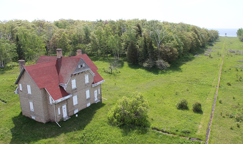 Aerial view of Plum Island shoreline with a historic house