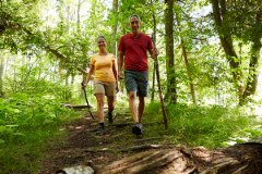 A couple hiking on a wooded trail