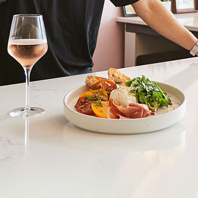 Plated food and a glass of wine