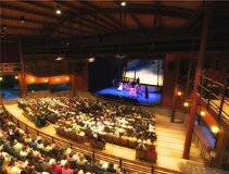 Performers indoors in front of a crowd.