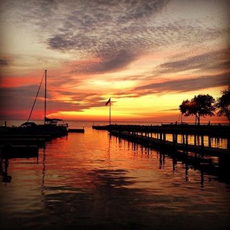 An orange red and yellow sunset over the marina.