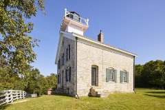 A lighthouse surrounded by trees.
