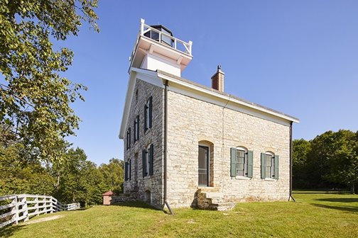 A lighthouse surrounded by trees.