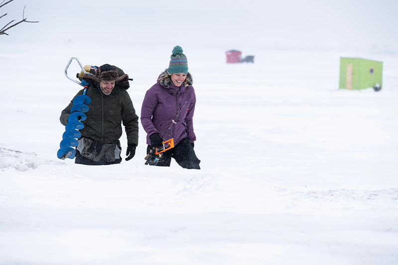 A couple heads out to ice fish at George Pinney Park.