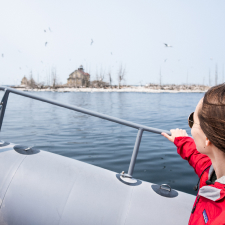 A woman on a boat holding the railing