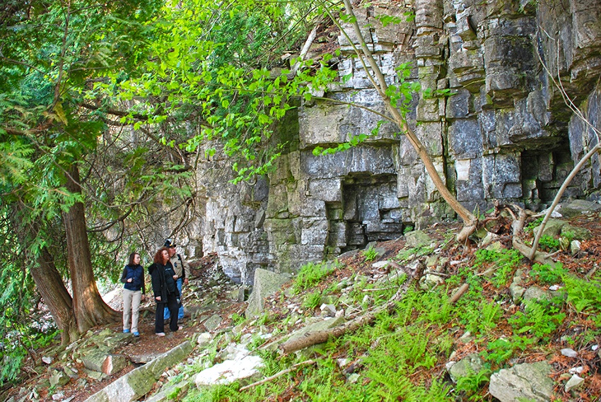 A family hikes a trail along the Niagara Escarpment in search of geocaches