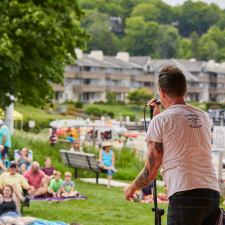 Man singing in front of a crowd.