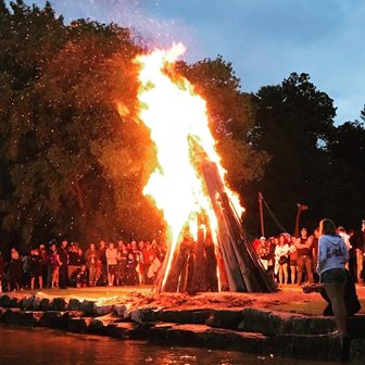 People standing around a large bonfire.