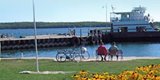 People sitting on a bench in front of Washington Island Dock.