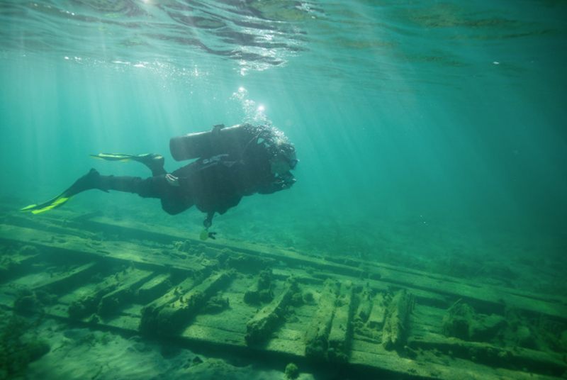 Profile of a scuba driver near shipwreck