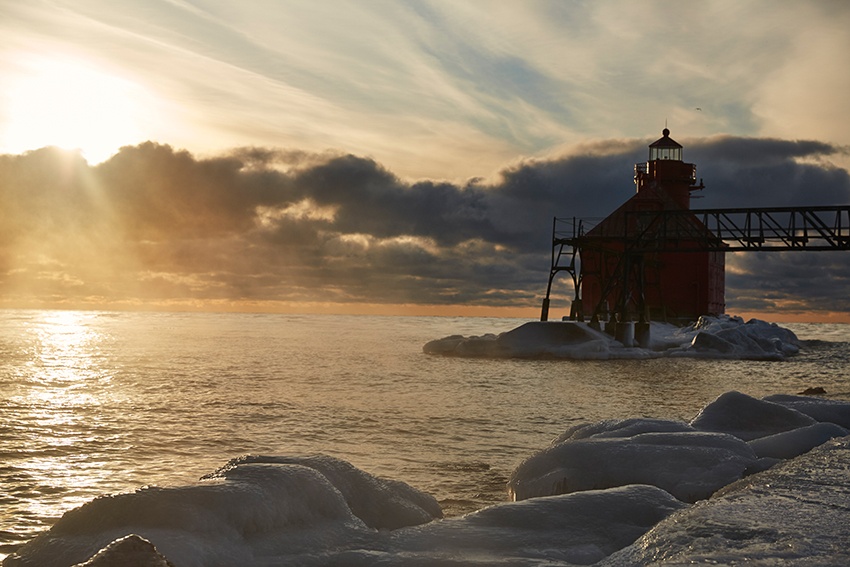 The Sturgeon Bay Pierhead Light bathed in sunrise golds and blues