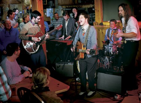 People watching a band play at a bar.