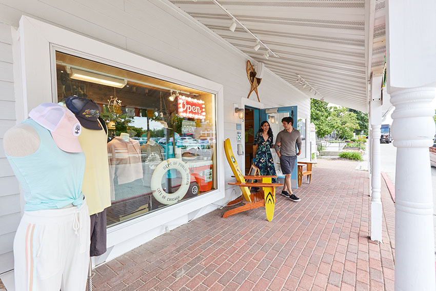 A couple window shopping at a stylish boutique.