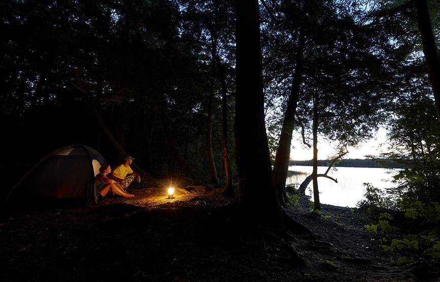 Campers beside a fire.