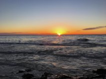 The sun setting over the lake.