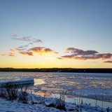 The snow-covered beach at the lake.