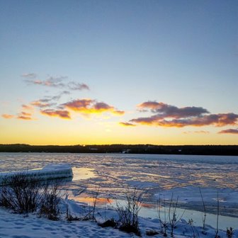 The snow-covered beach at the lake.