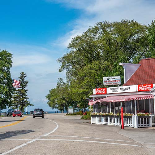 Cars driving past a roadside restaurant