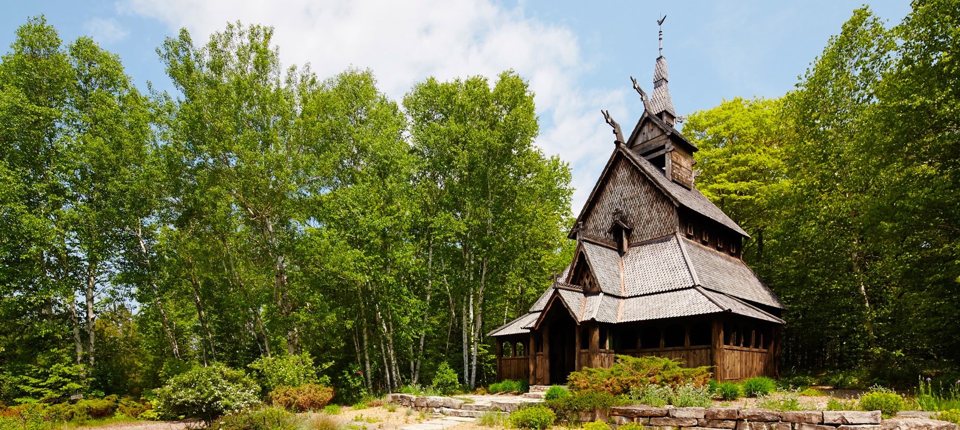 Wooden building in a clearing surrounded by trees