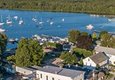 A town with many sailboats out on the lake from the air.