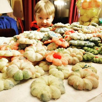 A child smiling looking at cookies.