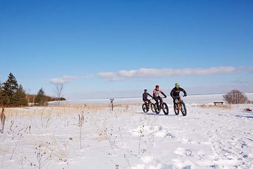 Three bikers on the sand