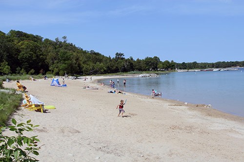 A pristine Egg Harbor beach with a few beachgoers.