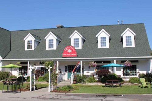 The quaint and old-fashioned exterior of Door County Coffee on a summer day.